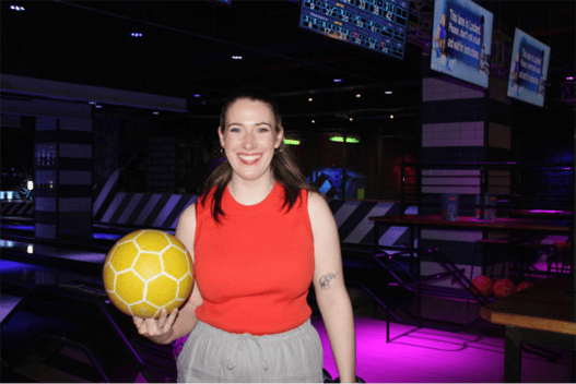 Morag Dine, head of growth, holding a bowling ball at Roxy Lanes in Edinburgh