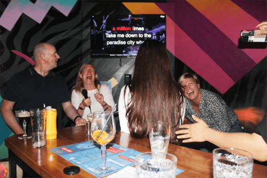 Component Sense team members singing in karaoke room