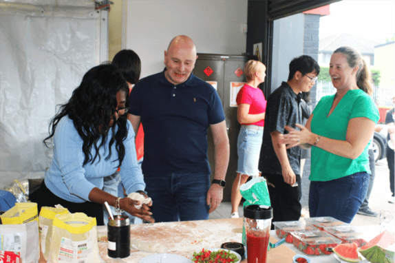 Component Sense team laughing and making pizza from scratch together