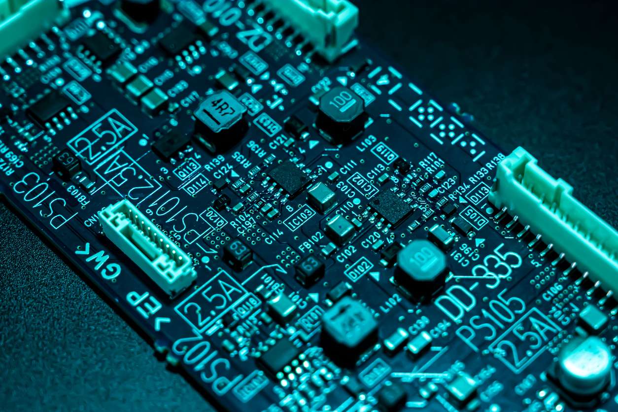 Close up of an integrated circuit board in neon blue lighting in Component Sense transparent logo shape.